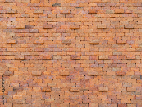 The ancient red brick wall stood tall and imposing  its intricate details and wear adding to its rugged charm. The wall stretched on for what seemed like an eternity