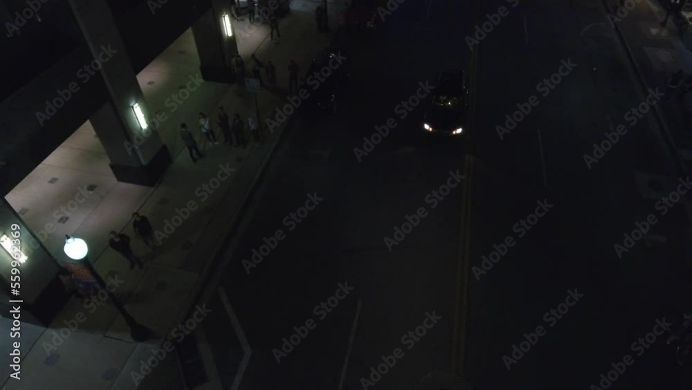 Aerial shot of a car waiting in the middle of a street at night in downtown Georgia Aerial shot of a car waiting in the middle of a street at night in downtown Georgia