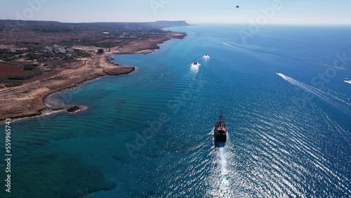 Areal shot of sailing ships and boats in Ayia Napa coast, tourist Black pearl boatrip in crystal clear sea. photo