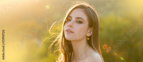 Spring woman on sunlight romantic portrait, sensual sunny face. Banner for website header. Natural female beauty. Young woman with clean fresh skin. photo