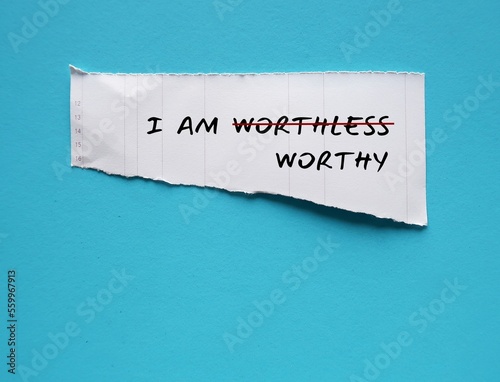 Konstfotografi Torn white paper on copy space blue background with text I AM WORTHLESS change t