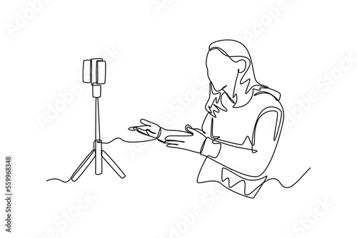 Single one line drawing happy girl recording vlog video blog at home using camera. Vlogging concept. Continuous line draw design graphic vector illustration.