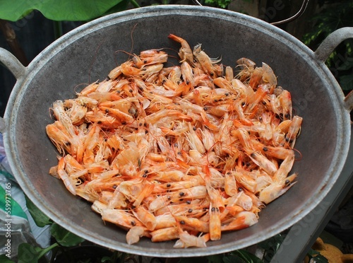 dried shrimp shells on a frying pan closeup out of focus