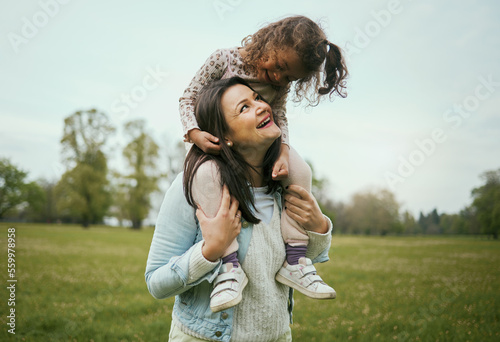 Fototapeta Park, mother and girl sitting shoulders for happiness, bonding or care on nature walk together in spring