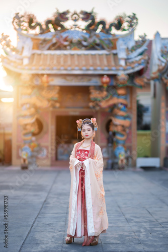 Portrait smile Cute little Asian girl wearing Chinese costumes decoration for Chinese new year festival celebrate culture of china at Chinese shrine Public places in Thailand © Thinapob