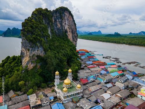 Aerial view over the floating fishing village at Ko Panyi (or Koh Panyee) one of famous travel destination in Phang Nga Bay, Phang Nga province, Thailand. photo