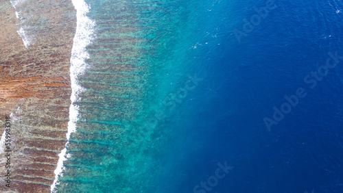 Sea waves reaching tropical beach on Nusa Lembongan, aerial landscape of island near Bali, Indonesia. Summer travel concept.