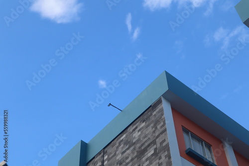 Perspective and lower angle view of the hotel building against the bright blue sky