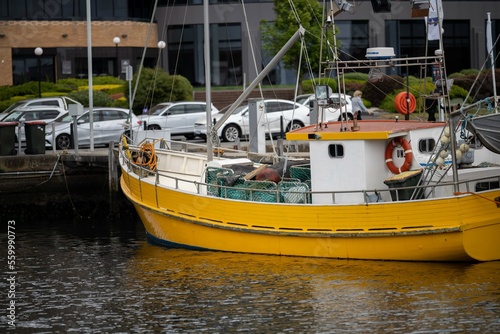 fishing boat moored to a buoy in a marina in spring