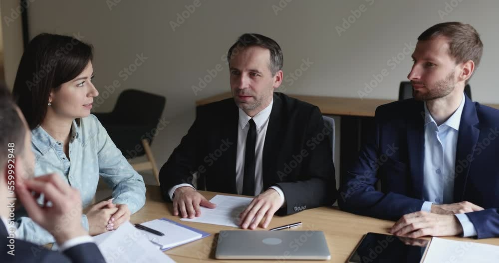 Negotiations between businesspeople. Middle-aged businessman make speech during formal meeting with investors, share information, speak to business partners clients lead official appointment in office Negotiations between businesspeople. Middle-aged businessman make speech during formal meeting with investors, share information, speak to business partners clients lead official appointment in office