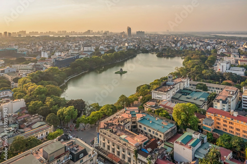 Hanoi, Vietnam - May 04, 2022: Top view aerial photo from flying drone of Hoan Kiem lake, Hanoi City with development buildings, transportation, energy power infrastructure. 