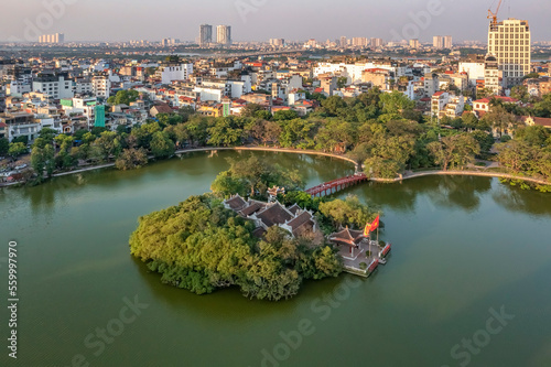 Top view aerial of Ngoc Son temple, Hoan Kiem Lake, Hanoi City with development buildings, transportation, energy power 