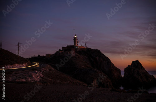Lighthouse of Cabo de Gata, Almeria, Spain, during sunset with light trails of car