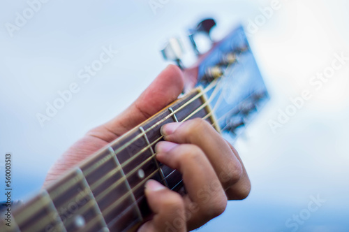 Isolated Acoustic Guitar s Fretboard with Fingers in Action