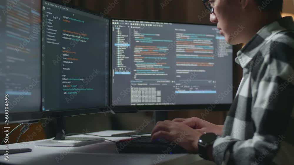 Close Up Of Asian Male Programmer Creating Innovative Software Engineer Developing App, Program, Video Game On Desktop Computer At Home. Terminal With Coding Language 
