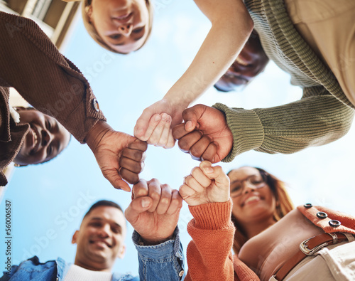Foto Group of friends, hands bump in huddle and group diversity, team building circle from below