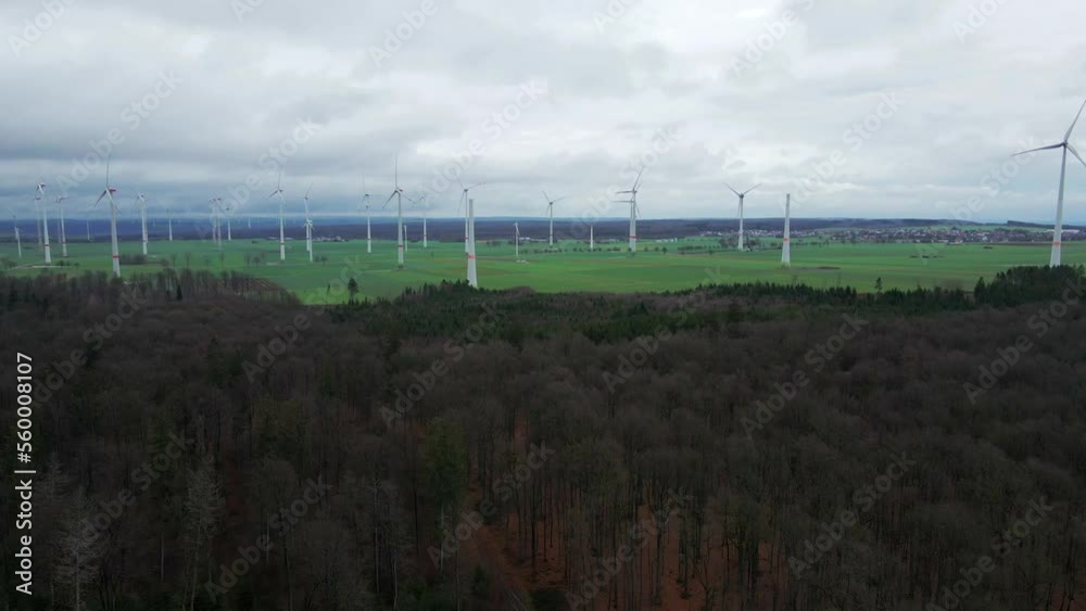 Sustainable Energy Production in North Rhine-Westphalia: Row of Wind Turbines at Wind Farm near Bad Wünnenberg, Paderborn Surrounded by Trees Sustainable Energy Production in North Rhine-Westphalia: Row of Wind Turbines at Wind Farm near Bad Wünnenberg, Paderborn Surrounded by Trees