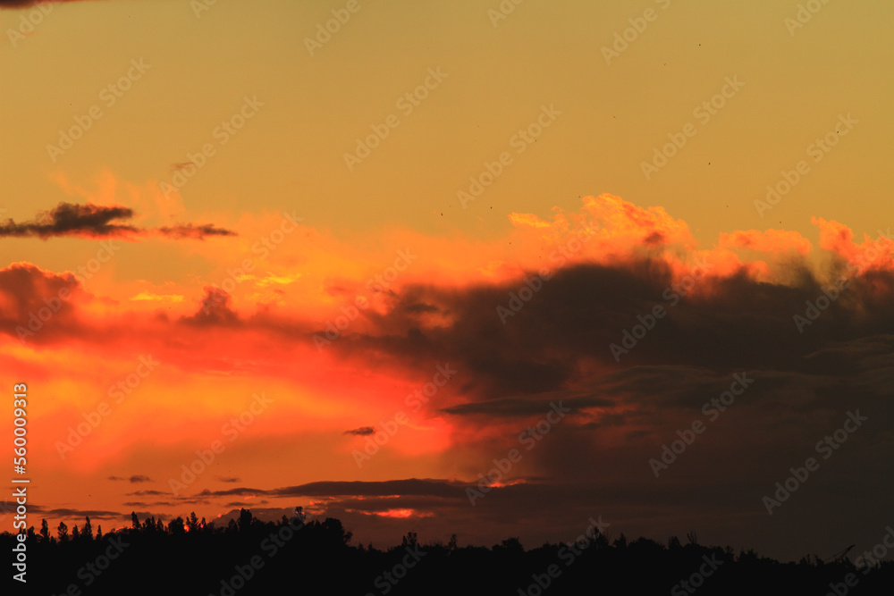 Sunset or dawn colorful sky with clouds. Wallpaper of an evening or morning sky