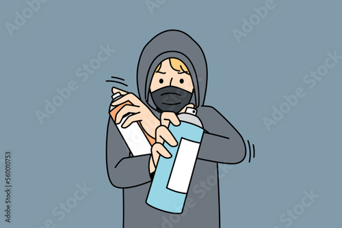 Young man in hood and face mask spraying with paint outdoors. Guy in hoodie painting graffiti with sprays outside. Hooligan activity. Vector illustration. 