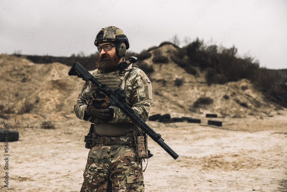 Fototapeta premium A man in military uniform with a rifle