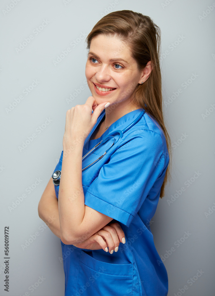 Smiling doctor woman standing side looking away. Isolated portrait of medical worker. Smiling doctor woman standing side looking away. Isolated portrait of medical worker.
