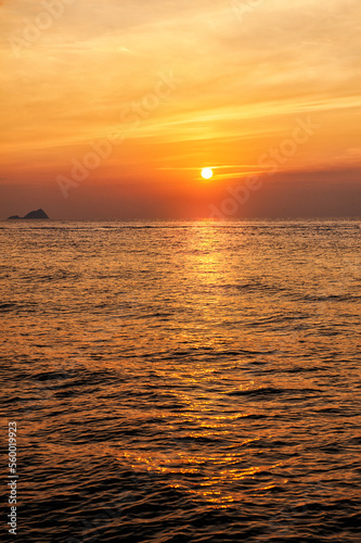 Beautiful sunset landscape with dramatic sky, sun and sea water