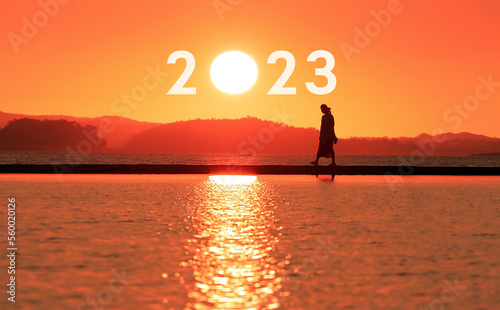 Transition from 2022 to 2023 New Year's concept, including text about the rising sun