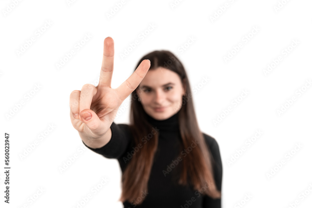 Peace !Beautiful brown-haired girl standing over isolated white background pointing at camera victory or peace sign. Number two. Peace !Beautiful brown-haired girl standing over isolated white background pointing at camera victory or peace sign. Number two.