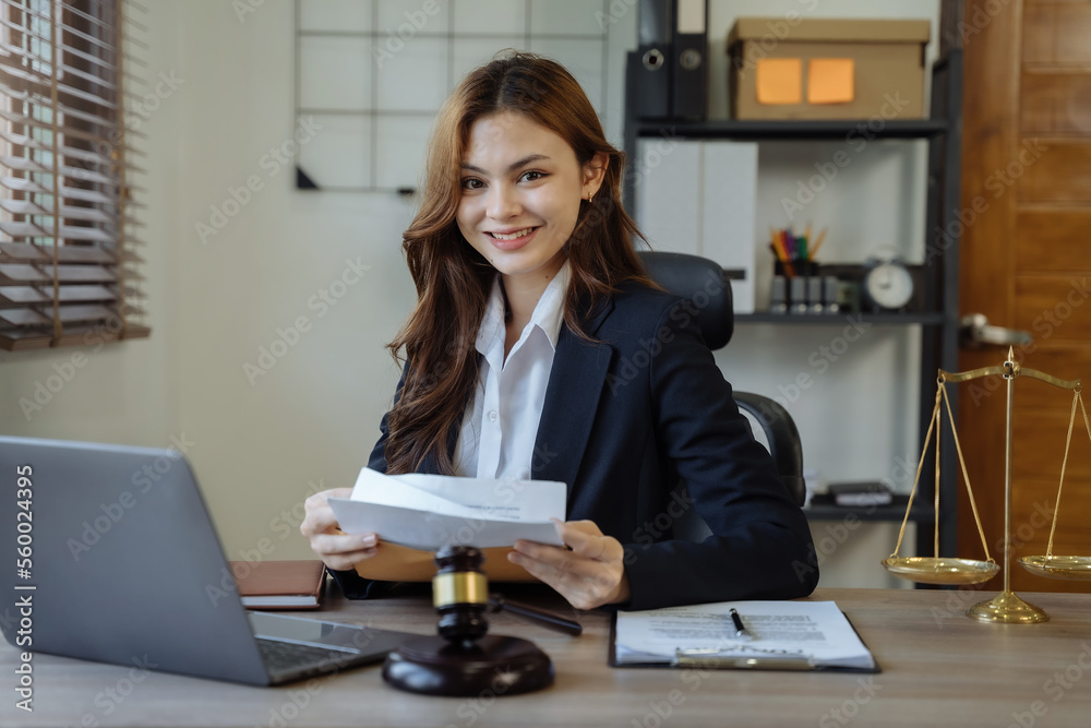Female asian sitting at the desk, looking to camera. Female asian sitting at the desk, looking to camera.