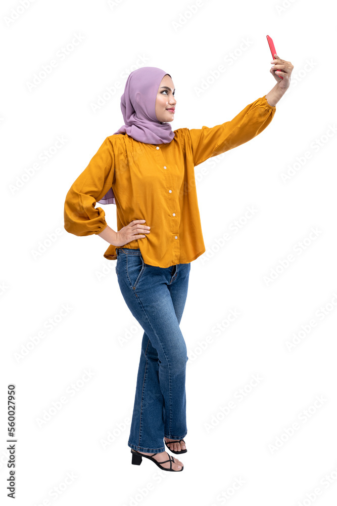 Asian Muslim woman in a headscarf using a mobile phone Asian Muslim woman in a headscarf using a mobile phone