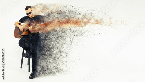 Photography a man with a guitar, an artist, a guitarist, a singer sits on a chair on a gray