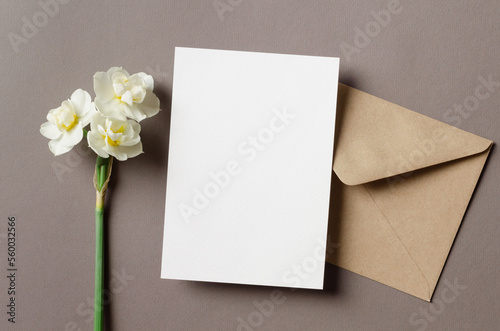 Invitation or greeting card mockup with envelope and spring flowers