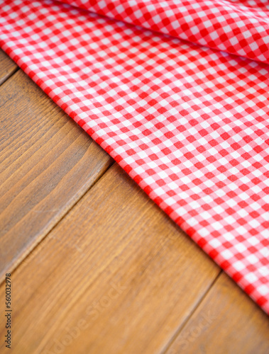 pink plaid fabric or tablecloth on wood desk with selective focus