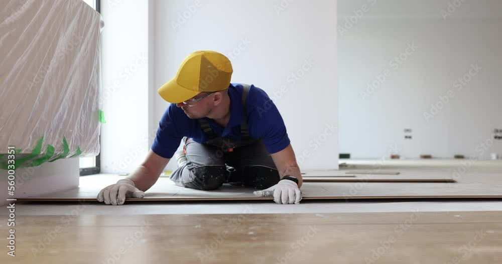 Master builder lays parquet floor laminate closeup Master builder lays parquet floor laminate closeup
