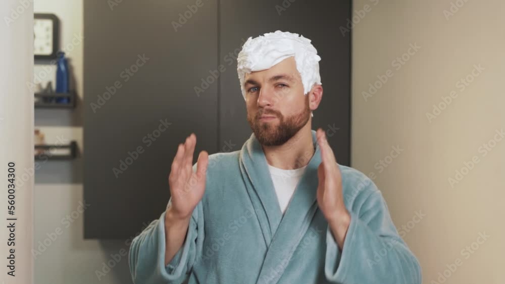 A man with a foam hairstyle is looking at the camera with satisfaction A man with a foam hairstyle is looking at the camera with satisfaction
