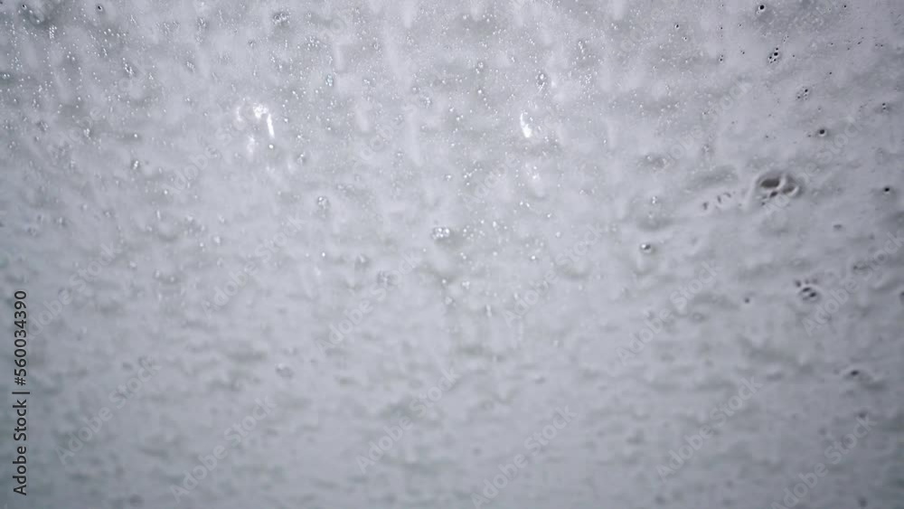 Inside view of a car being washed on an automatic machine. Automatic car washing from inside. Inside view of a car being washed on an automatic machine. Automatic car washing from inside.