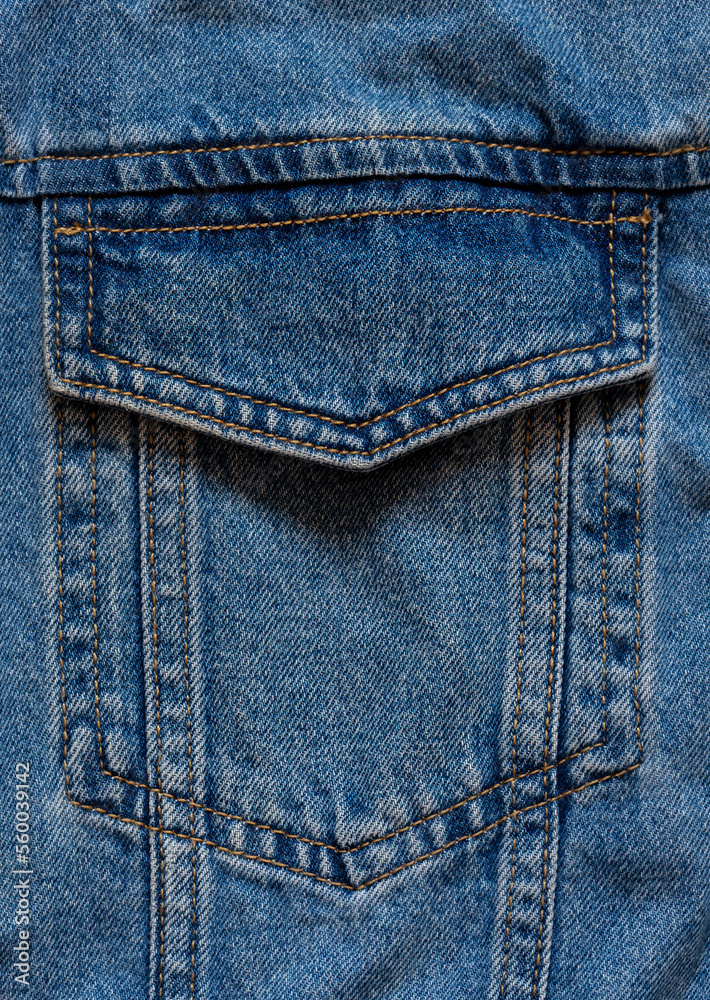 Fototapeta premium Blue denim fabric pocket macro texture. Close up