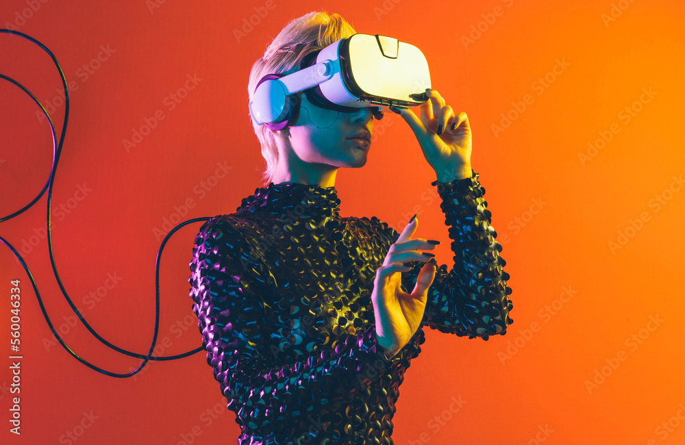 Representation of a bionic super human with advanced technology parts as vr visors and gadgets playing in a mixed reality training room. Futuristic cyberpunk evolution of human mankind and AI - obrazy, fototapety, plakaty 