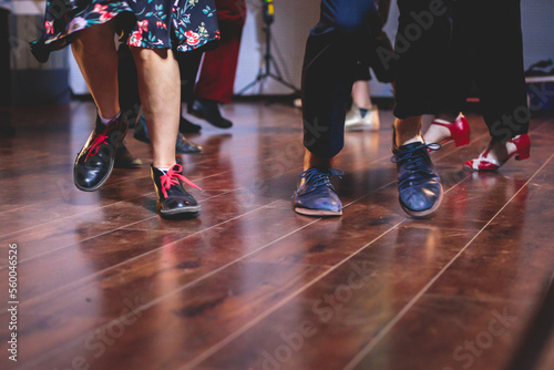 Dancing shoes of young couple dance retro jazz swing dances on a ballroom club wooden floor  close up view of shoes  female and male  dance lessons class rehearsal