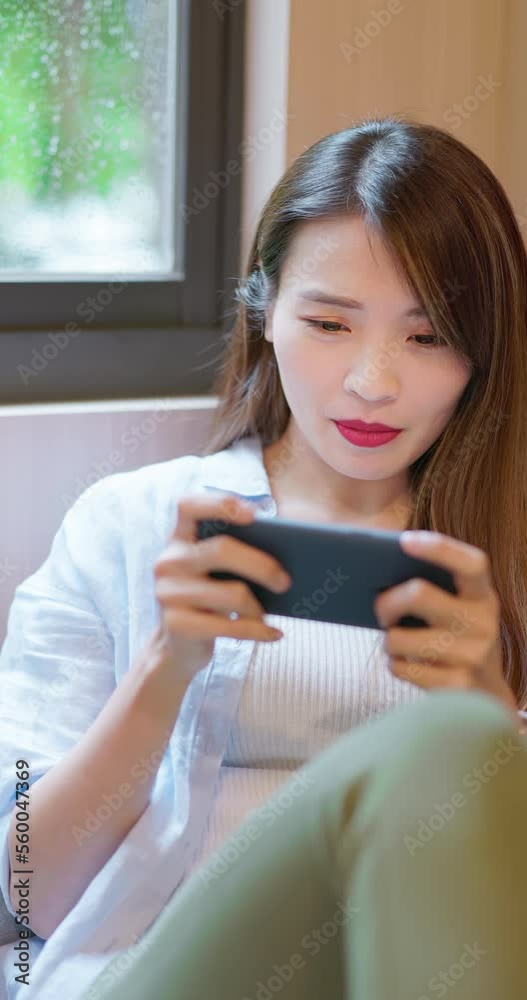 vertical woman play mobile games vertical woman play mobile games