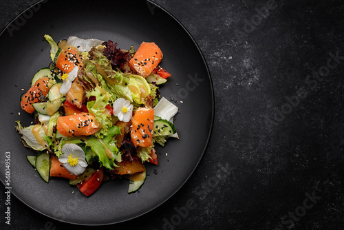 Salad with salmon and salad mix, on a plate