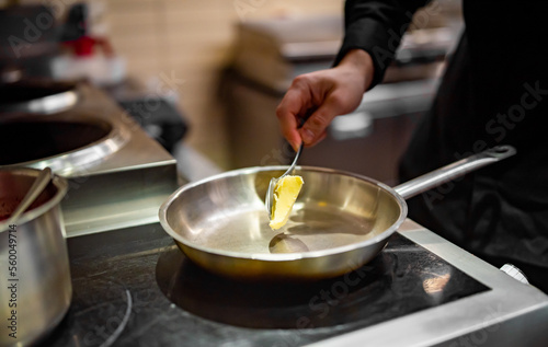chef frying butter in pan at kitchen