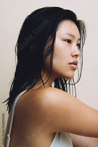 Portrait of a pretty Asian girl in profile with wet hair