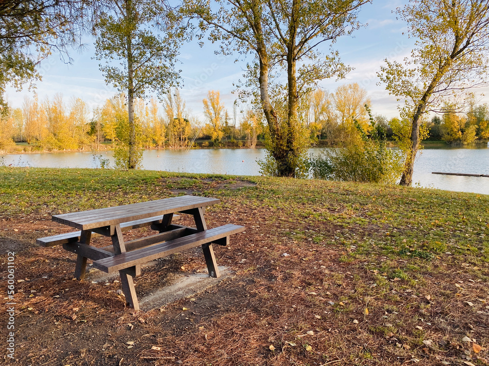 View on the lake Buzerens, Bram, France.  Wooden picnic table by the lake.