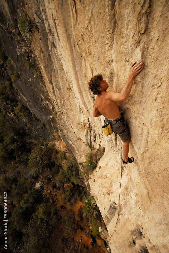 A rock climber ascends a steep rock face in Mexico. A rock climber ascends a steep rock face in Mexico.