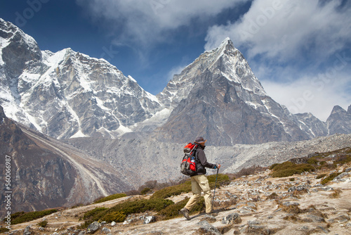 Hiker on way to Everest Base Camp with majestic Cholatse mountain in background, Pheriche, Khumbu, Nepal photo