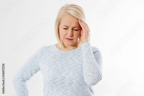 Women Hormonal Headaches. Closeup Middle aged woman with Menopause migraines isolated on white background. Copy space. Strong and hard female pain. Depression and stress health problem.