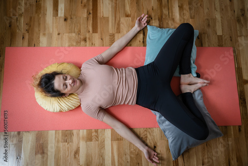 Print op canvas One adult caucasian woman practice restorative yoga at home