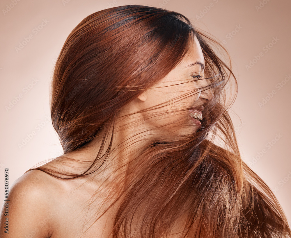Naklejka premium Shaking hair, beauty and cosmetics of a happy woman on studio background for luxury keratin treatment with shampoo product. Headshot of female posing for salon, hairdresser and wellness mockup