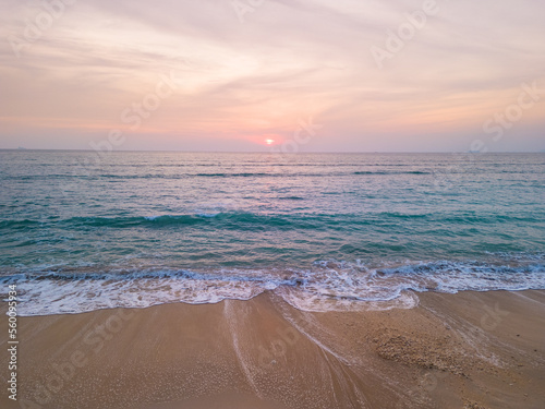 Aerial view of beautiful sandy beach at sunrise